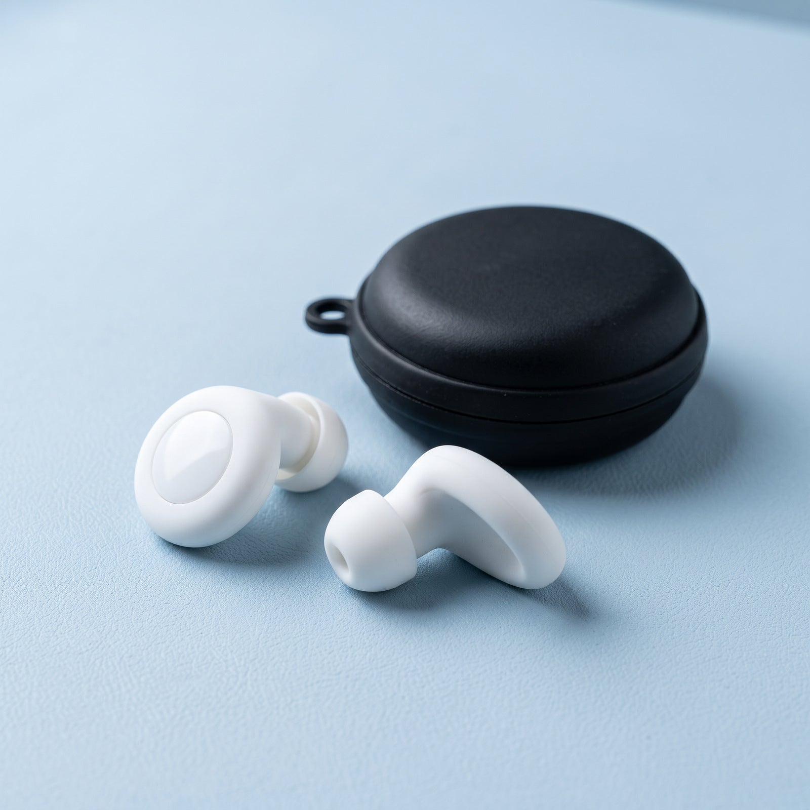 White Stillday pair beside its closed round case