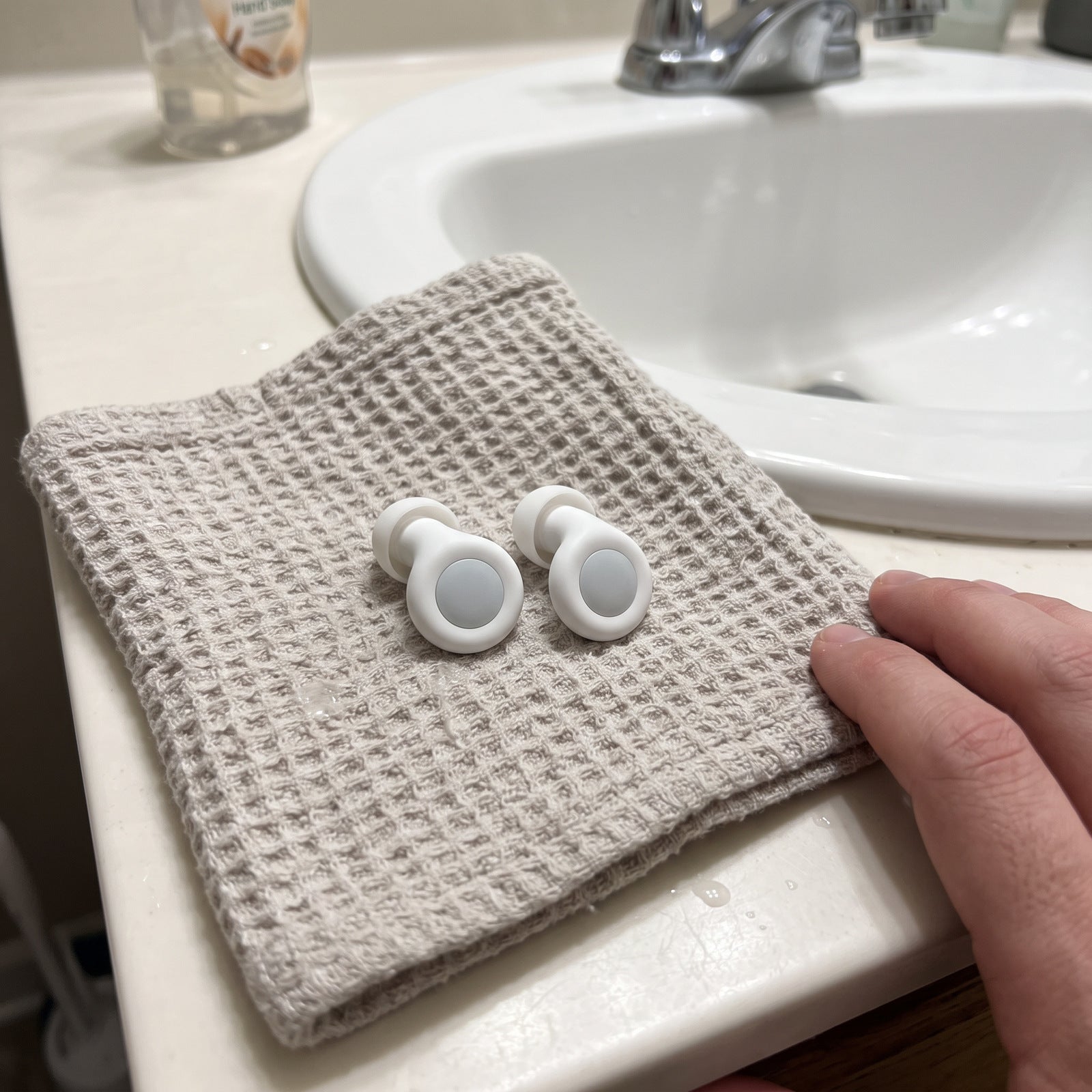 White Stillday pair drying on a clean cloth beside a bathroom basin